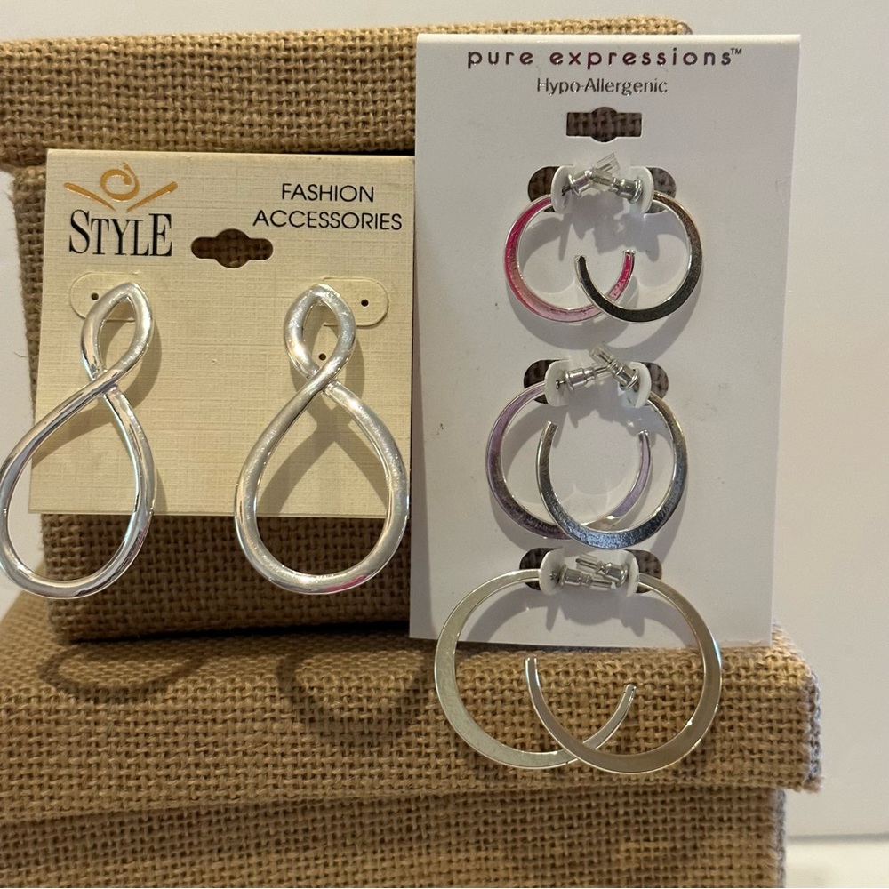 NWT 2 packs - 4 total pairs of silver tone earrings. Classic Hoop style 3 sizes